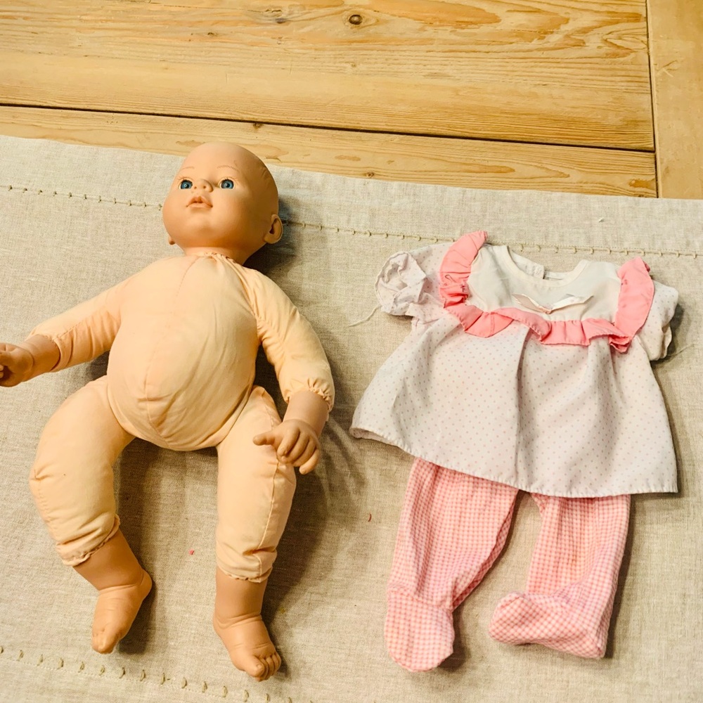 Baby Doll toy with pink white top and pants outfit